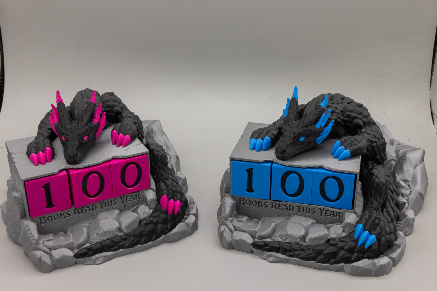 Dragon Reading Hoard Book Counter — Pink Hoard and Blue Hoard variants side by side, 3D printed by MacPack3D