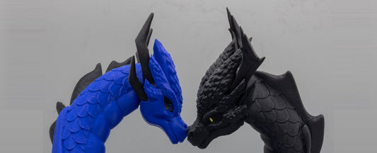 Draconic Bond 3D-printed bonded dragon pair — sapphire blue and midnight black dragon heads meeting nose to nose, centered
