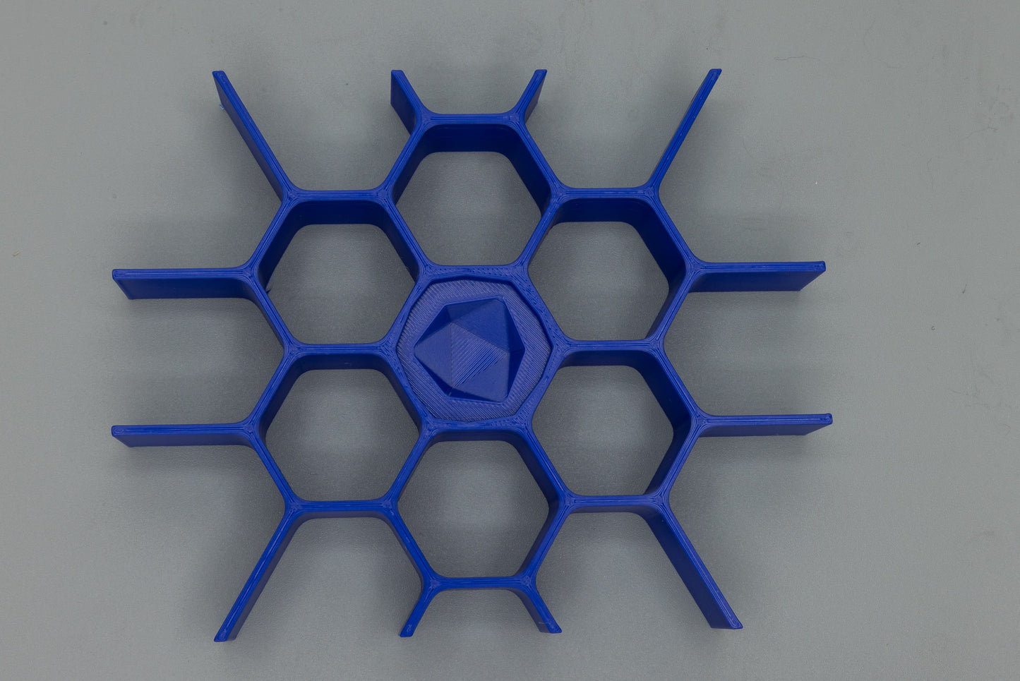 Electric-blue honeycomb dice insert for the Dragon Dice Book — dice not included