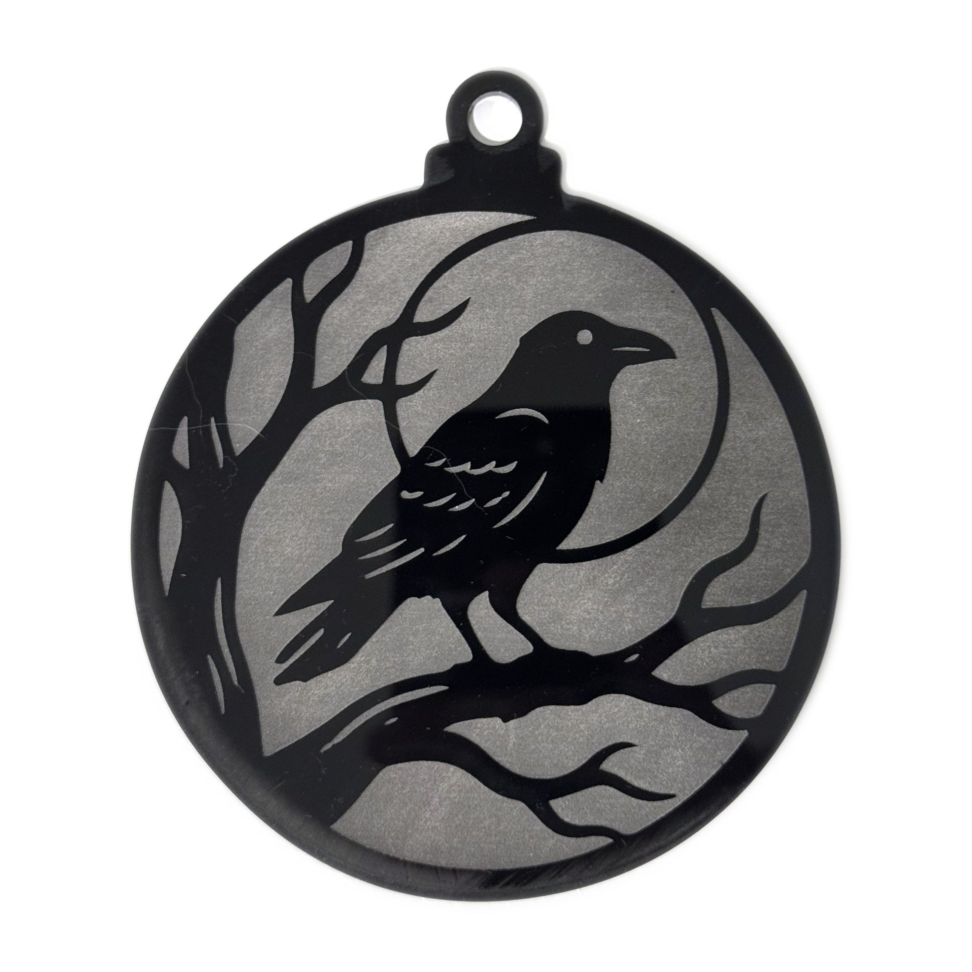 Raven Moon Halloween ornament — a raven perched on a bare branch against a full moon, engraved to a frosted grey finish on glossy black acrylic, 4.3 by 5.1 inches with a hanger loop